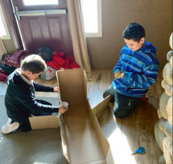 boys making cardboard sled