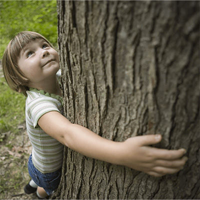 Child hugging a tree