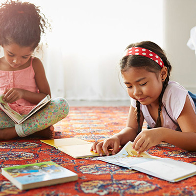 Two girls reading books 