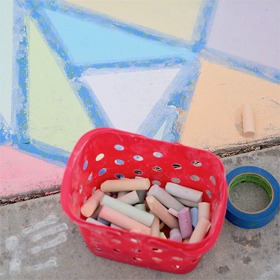 Sidewalk chalk art and basket of chalk 