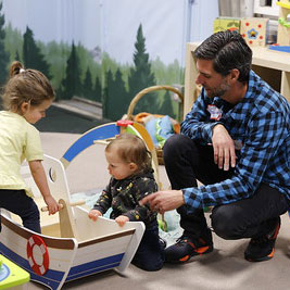 Dad playing with kids in baby area