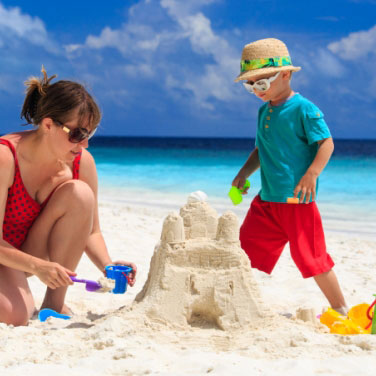 Woman and boy building a sand castle 