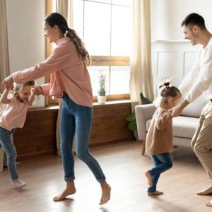 mother and father dancing with daughters 