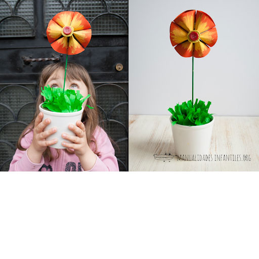 Child looking at flowers with paper rolls craft
