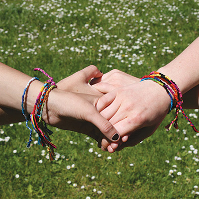 Holding hands with Friendship bracelets 
