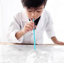 Boy blowing bubbles with straw