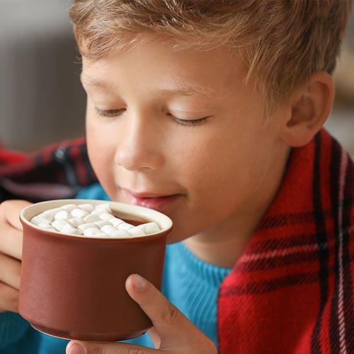 Boy sipping hot cocoa