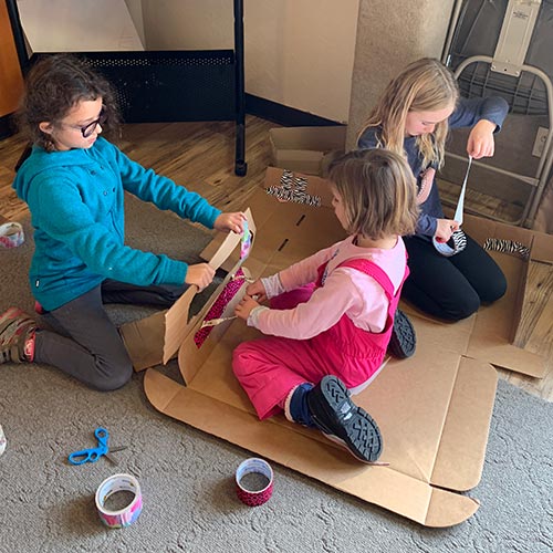 kids making cardboard sled