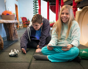 girl and boy programming lego robot