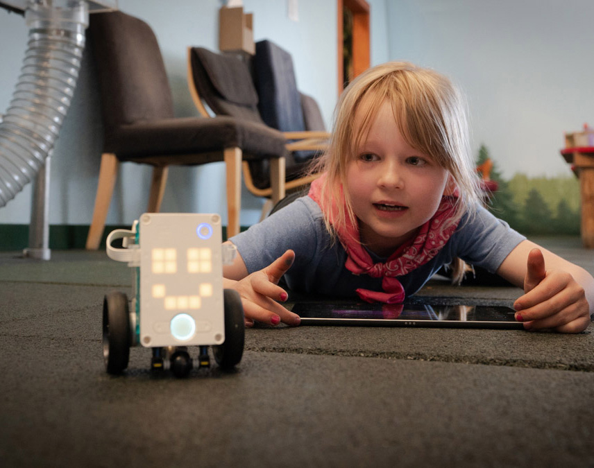 Girl with ipad and lego robot