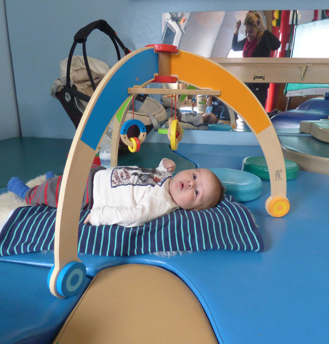 baby on blue matte looking at toy baby on blue matte looking at toy