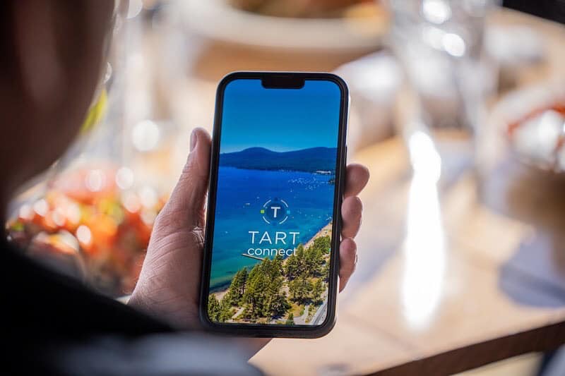 Someone holding a phone with the TART Connect app