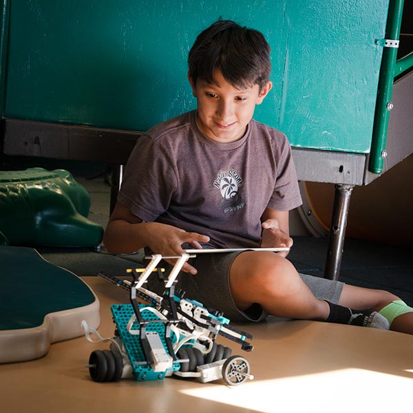 Middle schooler programming his robot