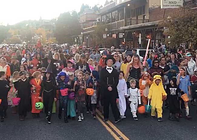 Families walking in the annual Halloween parade downtown Truckee